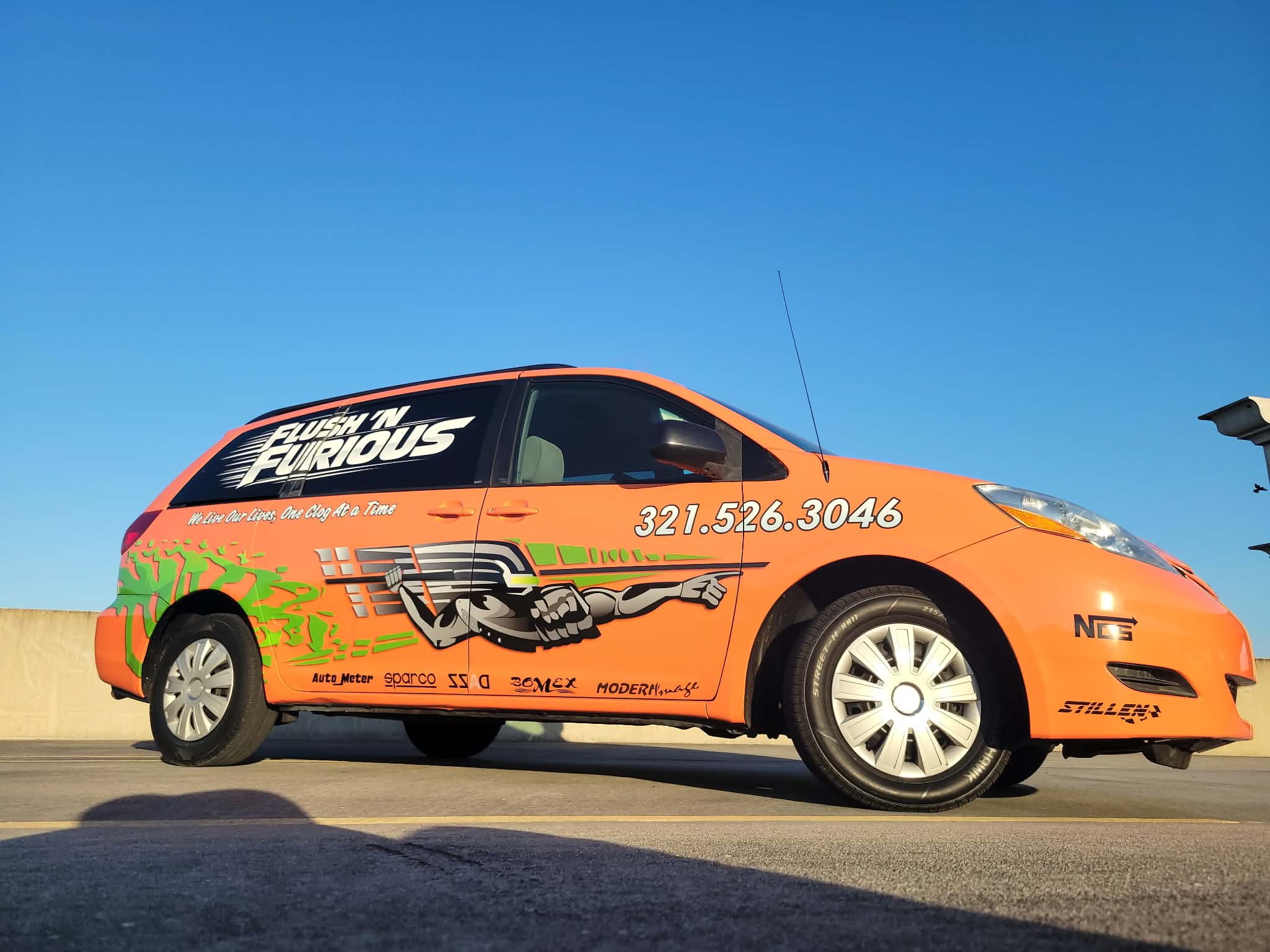 Orange Flush 'N Furious branded service van