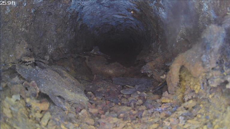 Sewer camera view showing heavy buildup inside a pipe